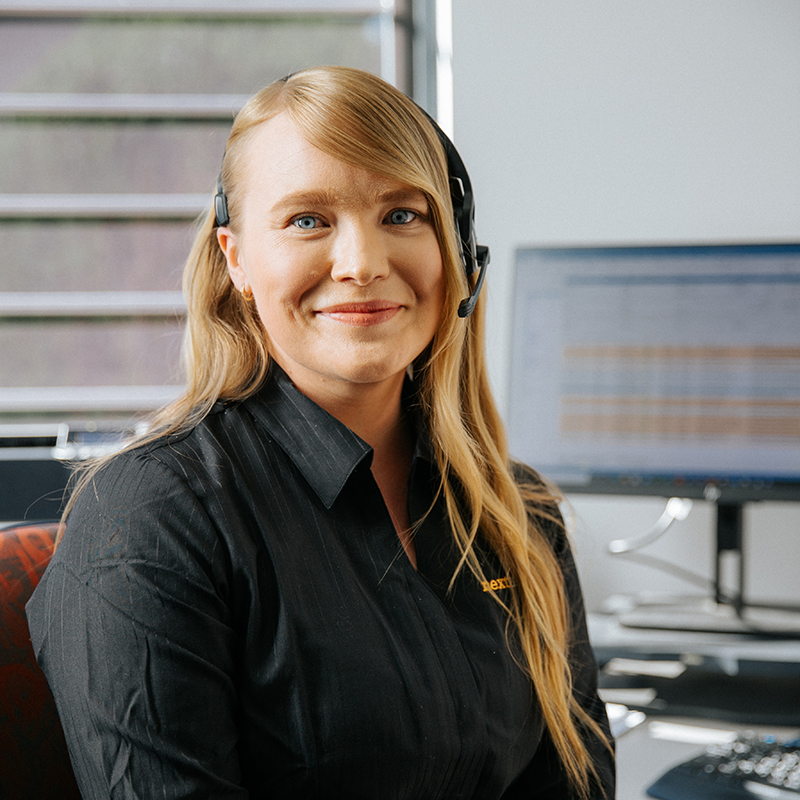 Smiling woman with headset in office