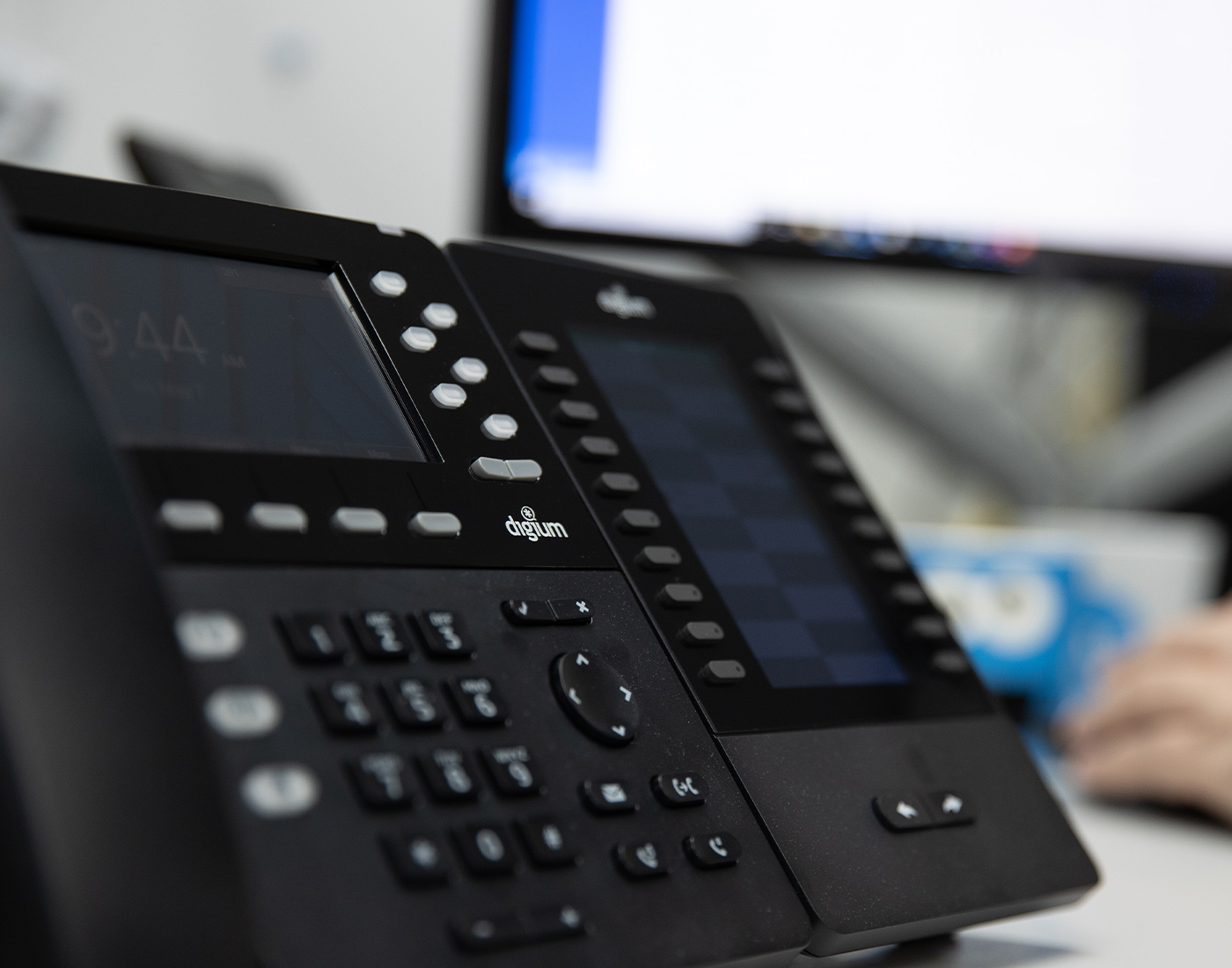 Close-up of office desk phones with digital displays