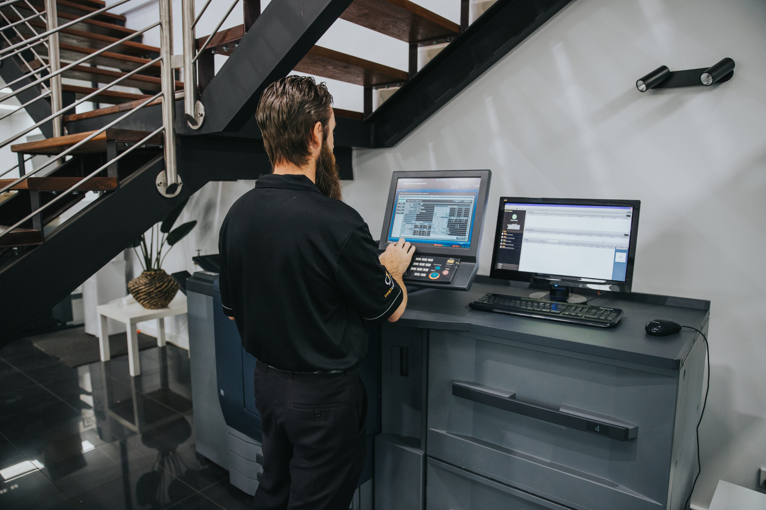 man using a production printer in the office
