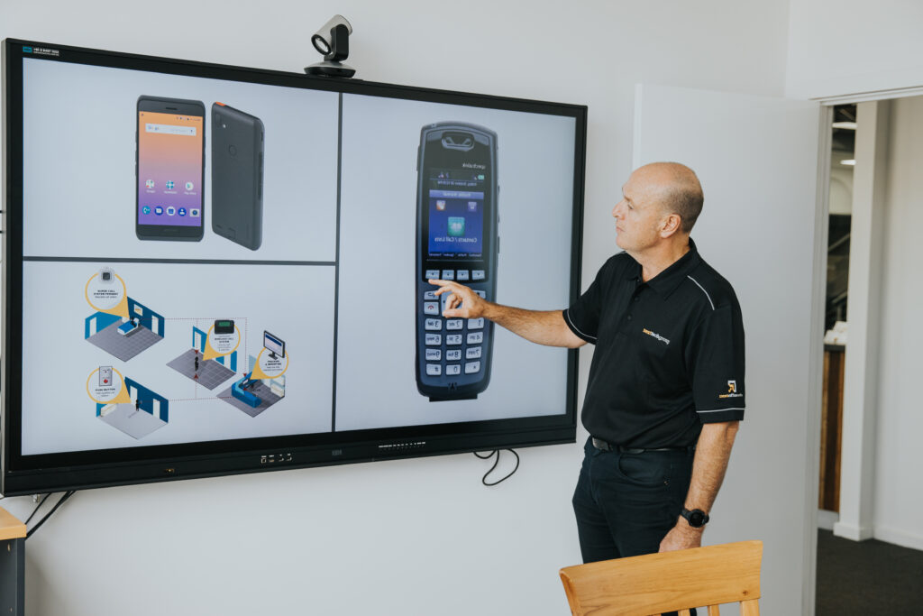 man using an interactive touch screen in a meeting room