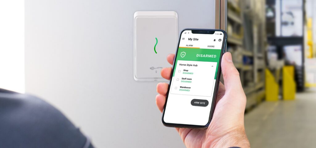 person using phone with access control app outside warehouse
