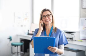 nurse on the phone with a clipboard