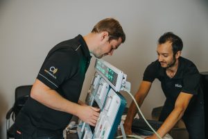 A15I2489 2 men installing a nurse call system