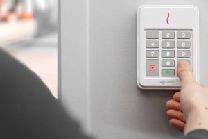 person using access control panel outside building