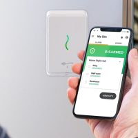 person using phone with access control app outside warehouse