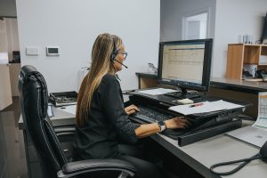 lady at desk using a phone headset
